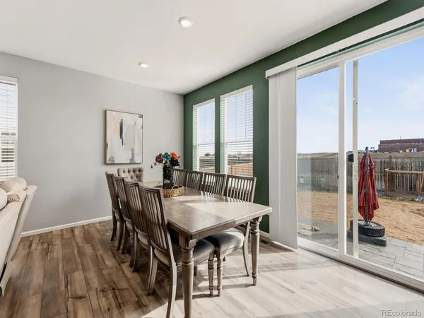 a view of a dining room with furniture window and wooden floor
