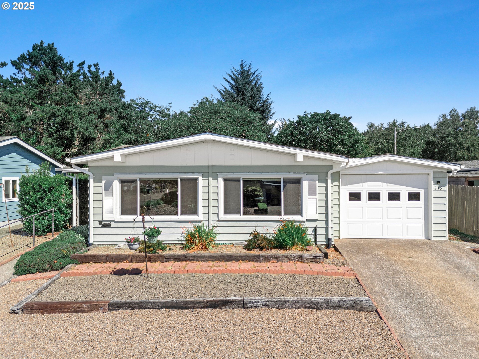 a front view of a house with a garden