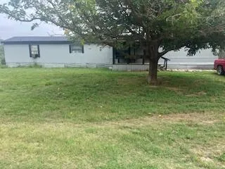 a kitchen with cabinets and wooden floor