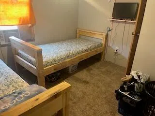 a view of a room with wooden floor