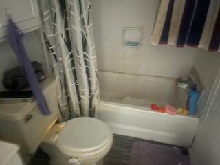 6806 North County Road 1630 Shallowater, TX 79363 - Photo 26 of 40 a white toilet sitting next to a bath tub