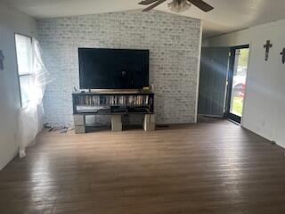 6806 North County Road 1630 Shallowater, TX 79363 - Photo 4 of 40 an empty room with wooden floor a fireplace and windows