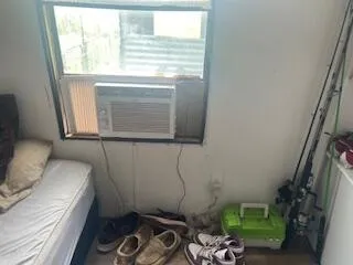 a bedroom with a bed and cabinet