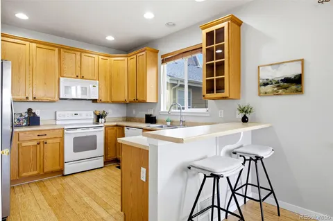 a kitchen with stainless steel appliances granite countertop a stove a sink dishwasher and a refrigerator