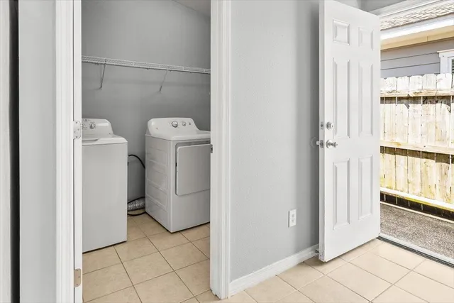 a view of a storage and utility room with washer and dryer