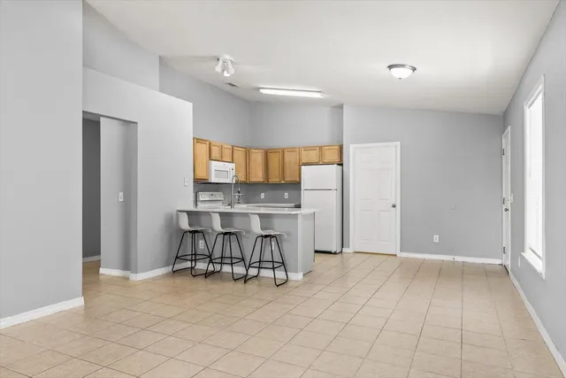a view of a livingroom with furniture and a window