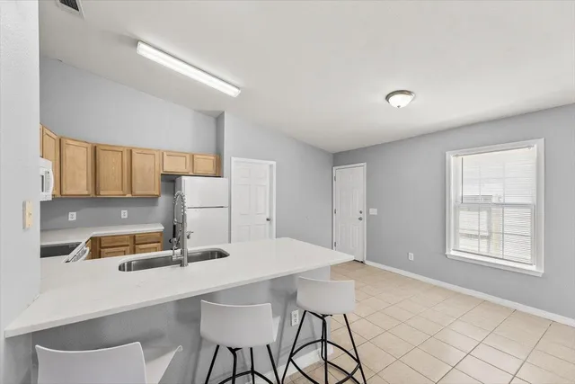 a kitchen with a sink cabinets and window