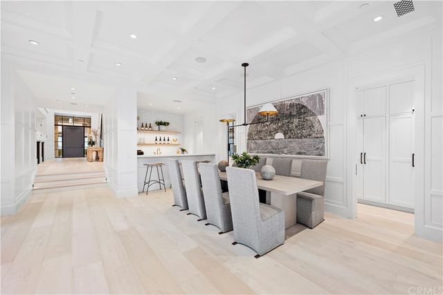 a view of a kitchen with kitchen island stainless steel appliances a counter top space and a view of living room