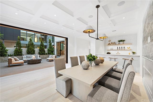 a view of a dining room with furniture large windows and wooden floor