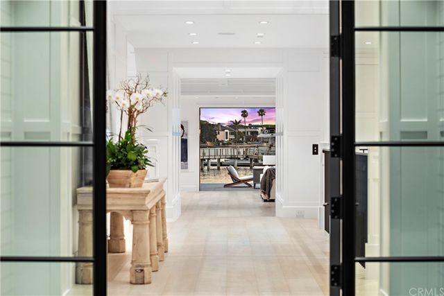 a view of a hallway with dining area and chandelier