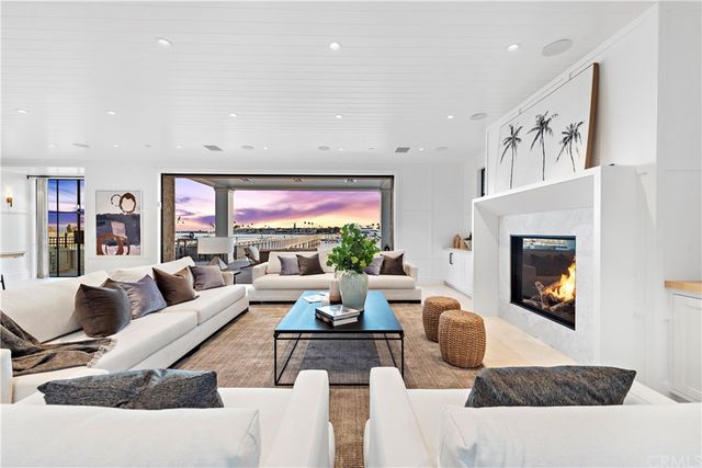 a living room with furniture large window and a fireplace