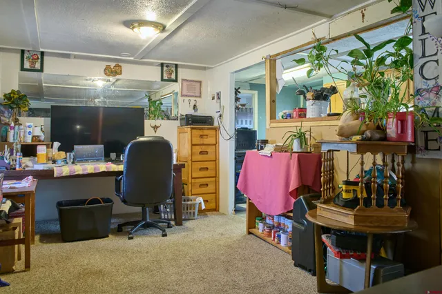 a living room with furniture and a clock