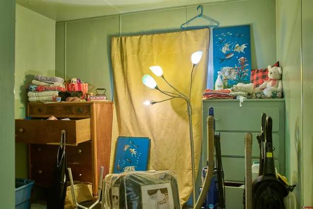 a bedroom with a bed and a lamp