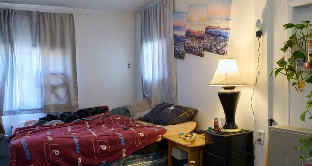 a bedroom with bed and a mirror