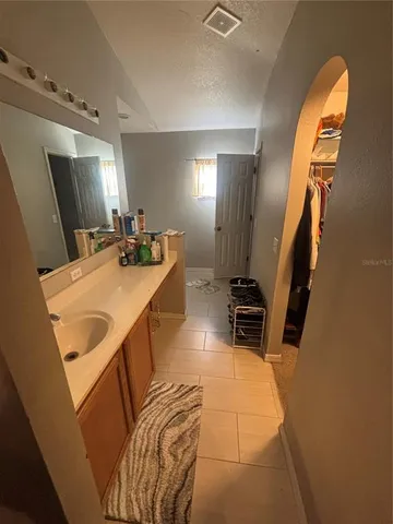 a bathroom with a sink a mirror and a shower