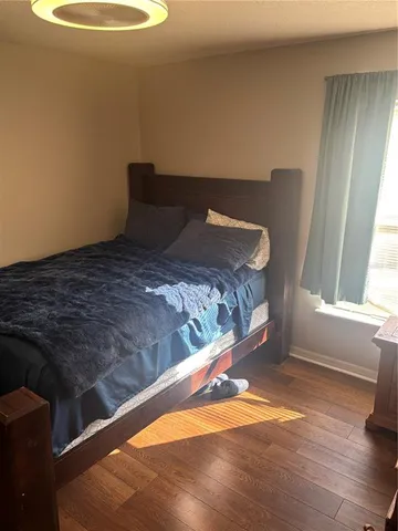 a bedroom with a bed and a window