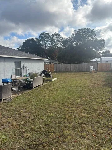 a view of a lake with lawn chairs