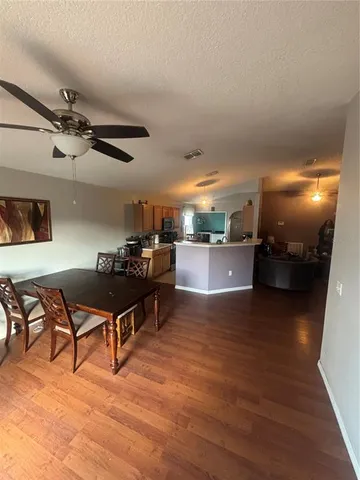 a living room with furniture and kitchen view