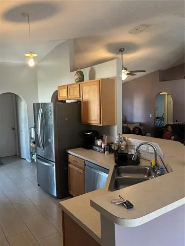 a kitchen with a sink a refrigerator and a stove