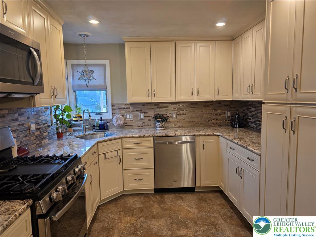 189 West Berger Street Emmaus, PA 18049 - Photo 5 of 26 a kitchen with stainless steel appliances granite countertop a stove a sink and a refrigerator