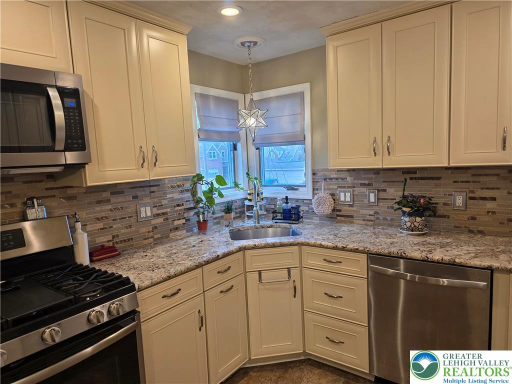 189 West Berger Street Emmaus, PA 18049 - Photo 6 of 26 a kitchen with granite countertop a sink a stove and cabinets