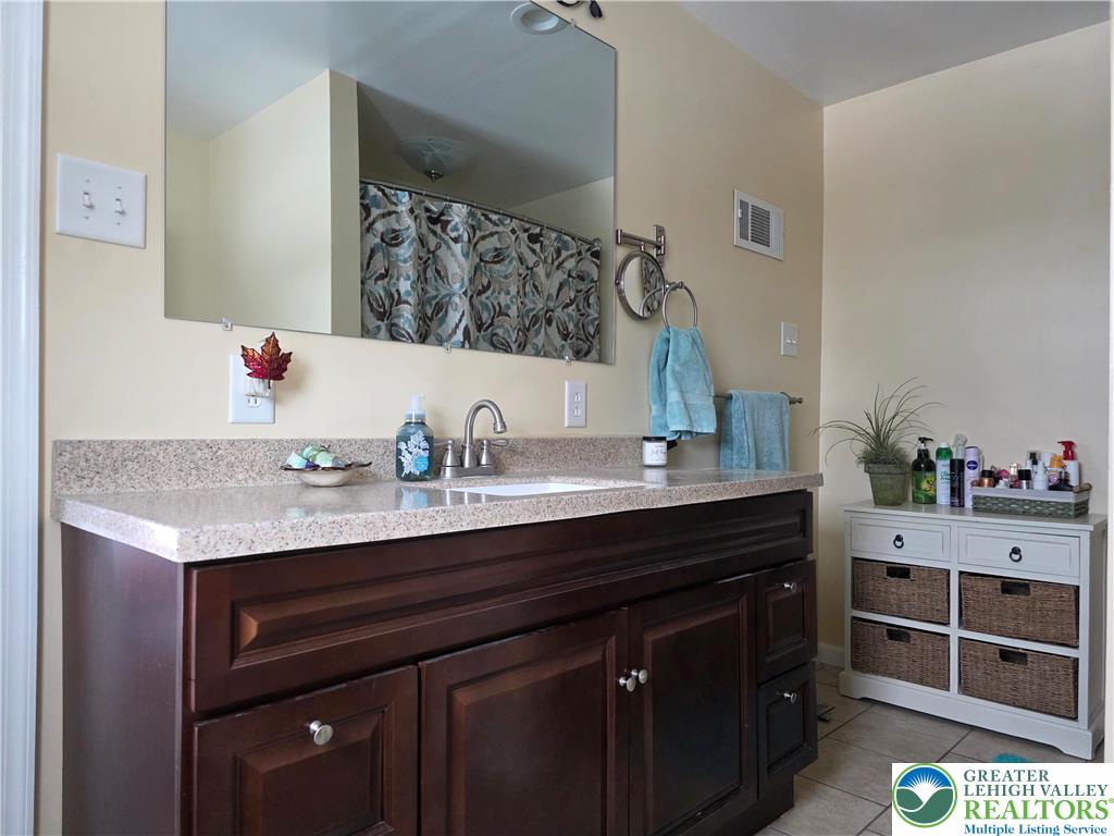 189 West Berger Street Emmaus, PA 18049 - Photo 9 of 26 a bathroom with a granite countertop sink and a mirror