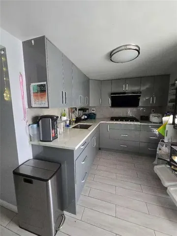 a kitchen with stainless steel appliances a stove a sink a microwave a refrigerator and cabinets