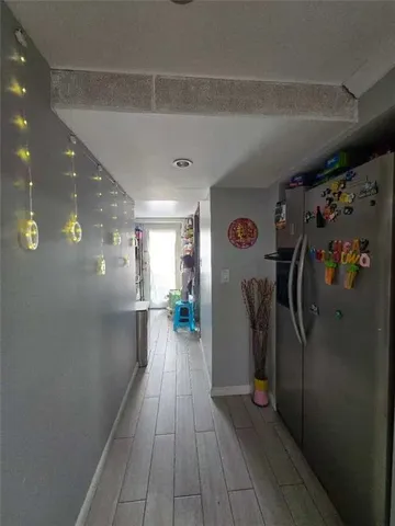 a view of a hallway with wooden floor