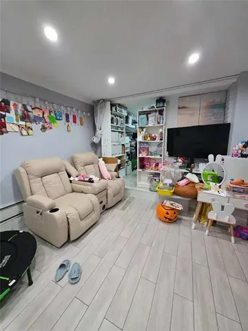 a playing room with furniture and a flat screen tv