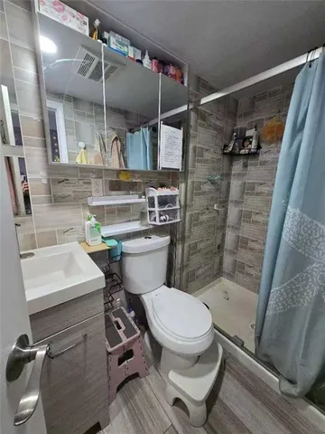 a bathroom with a sink toilet and shower