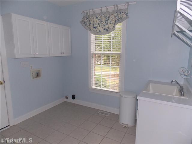 8501 Rosedale Drive Oak Ridge, NC 27310 - Photo 15 of 16 Laundry Room. Huge laundry room with outside entrance. and utility sink