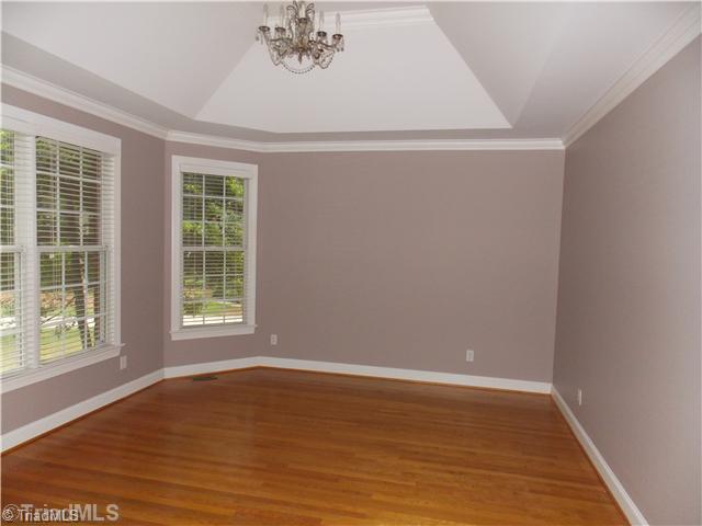 8501 Rosedale Drive Oak Ridge, NC 27310 - Photo 4 of 16 Living Room. Living room with tray ceiling.