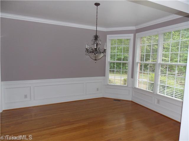 8501 Rosedale Drive Oak Ridge, NC 27310 - Photo 5 of 16 Dining Room. Dining room with lovely moldings and hardwood floors.