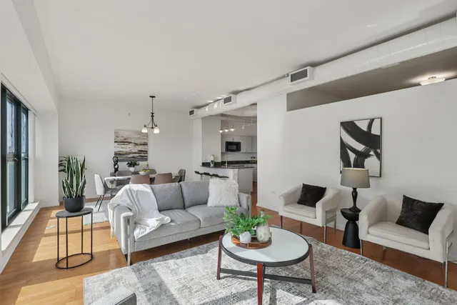 a living room with furniture and view of kitchen