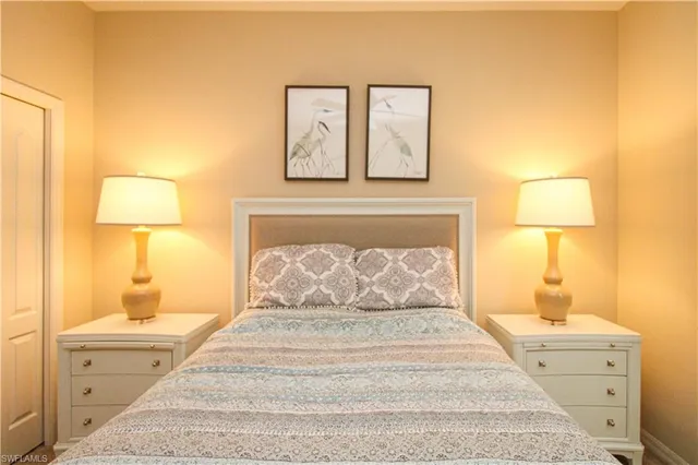 a bedroom with a bed and painting on the wall