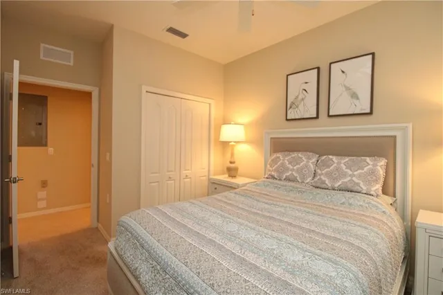 a bedroom with a bed and a lamp