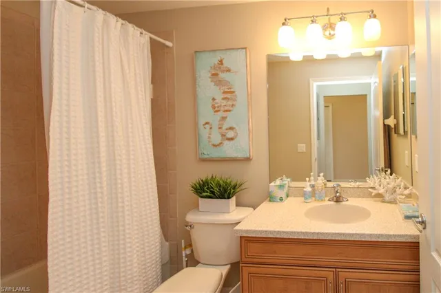 a bathroom with a sink toilet and a mirror