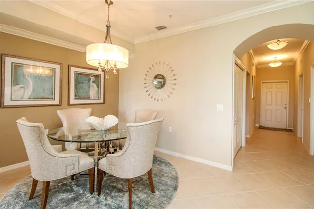 a living room with furniture a dining table and a flat screen tv
