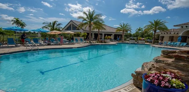 a view of a house with swimming pool yard and outdoor seating