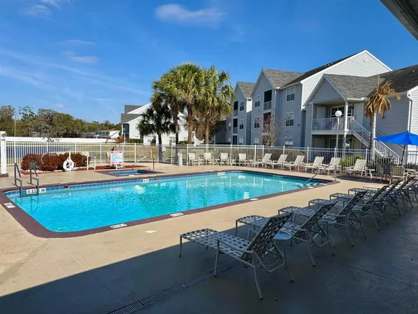 a view of a swimming pool with chairs
