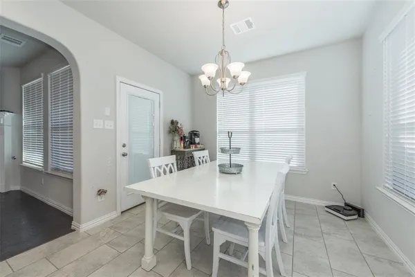 a view of a dining room with furniture and chandelier