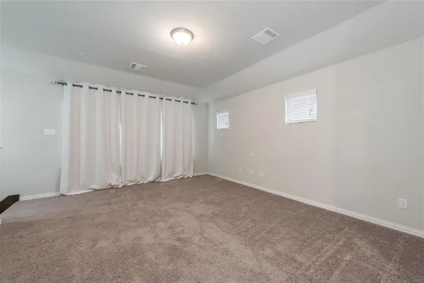 a bedroom with a bed table and chair