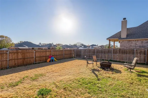 a view of a house with backyard patio and fire pit