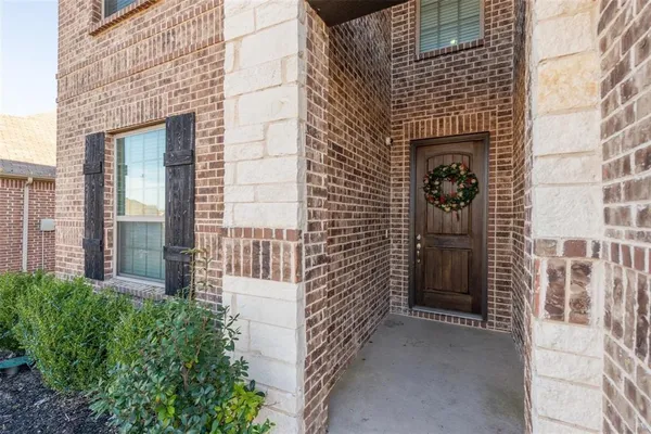 a view of a brick house with a large windows
