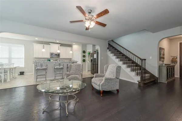 a room with lots of furniture and wooden floor