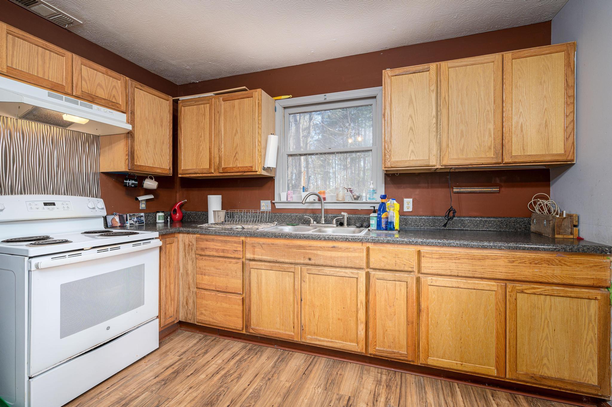 2 Laurel Brook Drive Flat Rock, NC 28731 - Photo 19 of 32 a kitchen with stainless steel appliances granite countertop a stove a sink and white cabinets