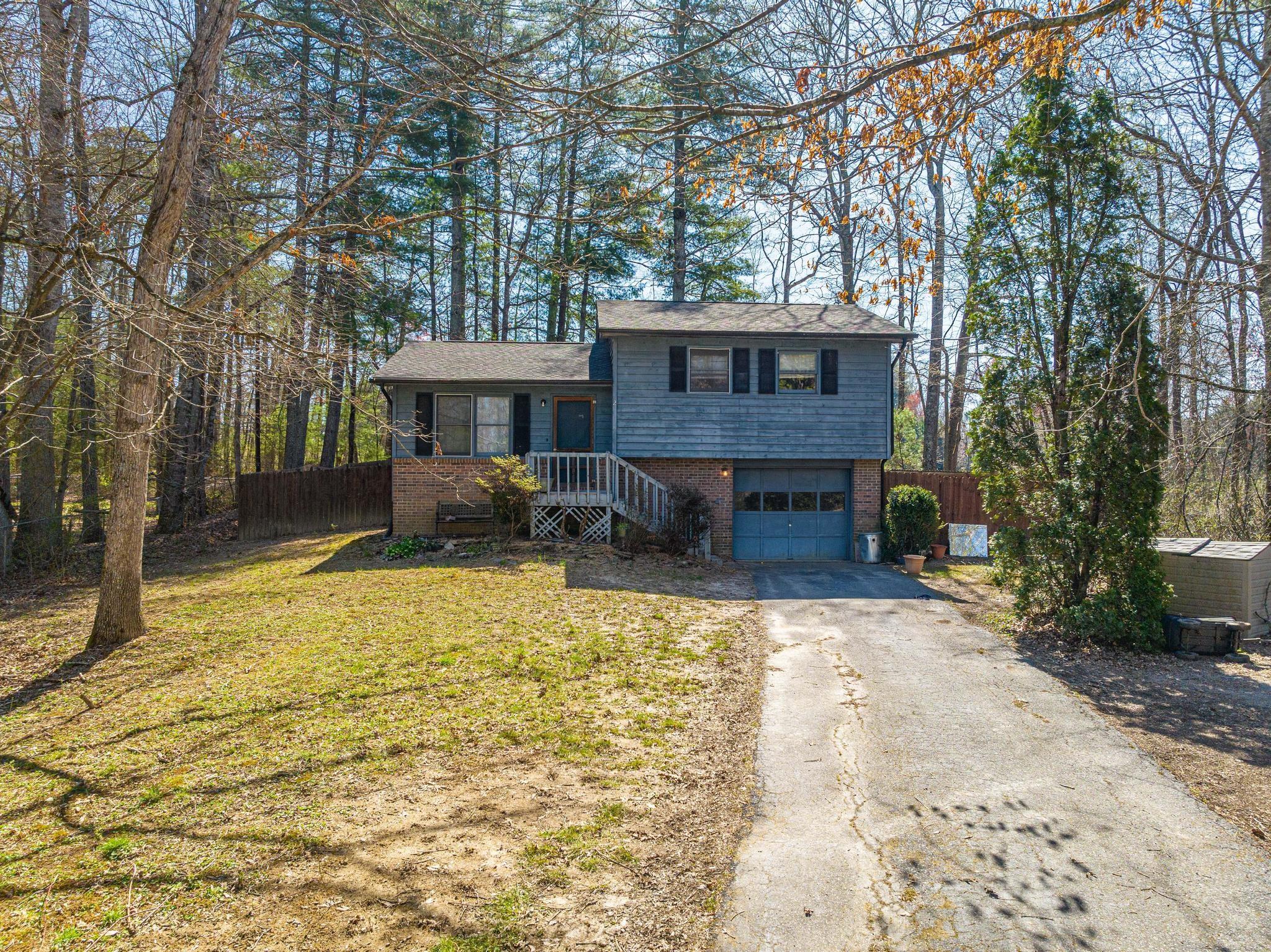 2 Laurel Brook Drive Flat Rock, NC 28731 - Photo 3 of 32 a front view of a house with yard patio and tree