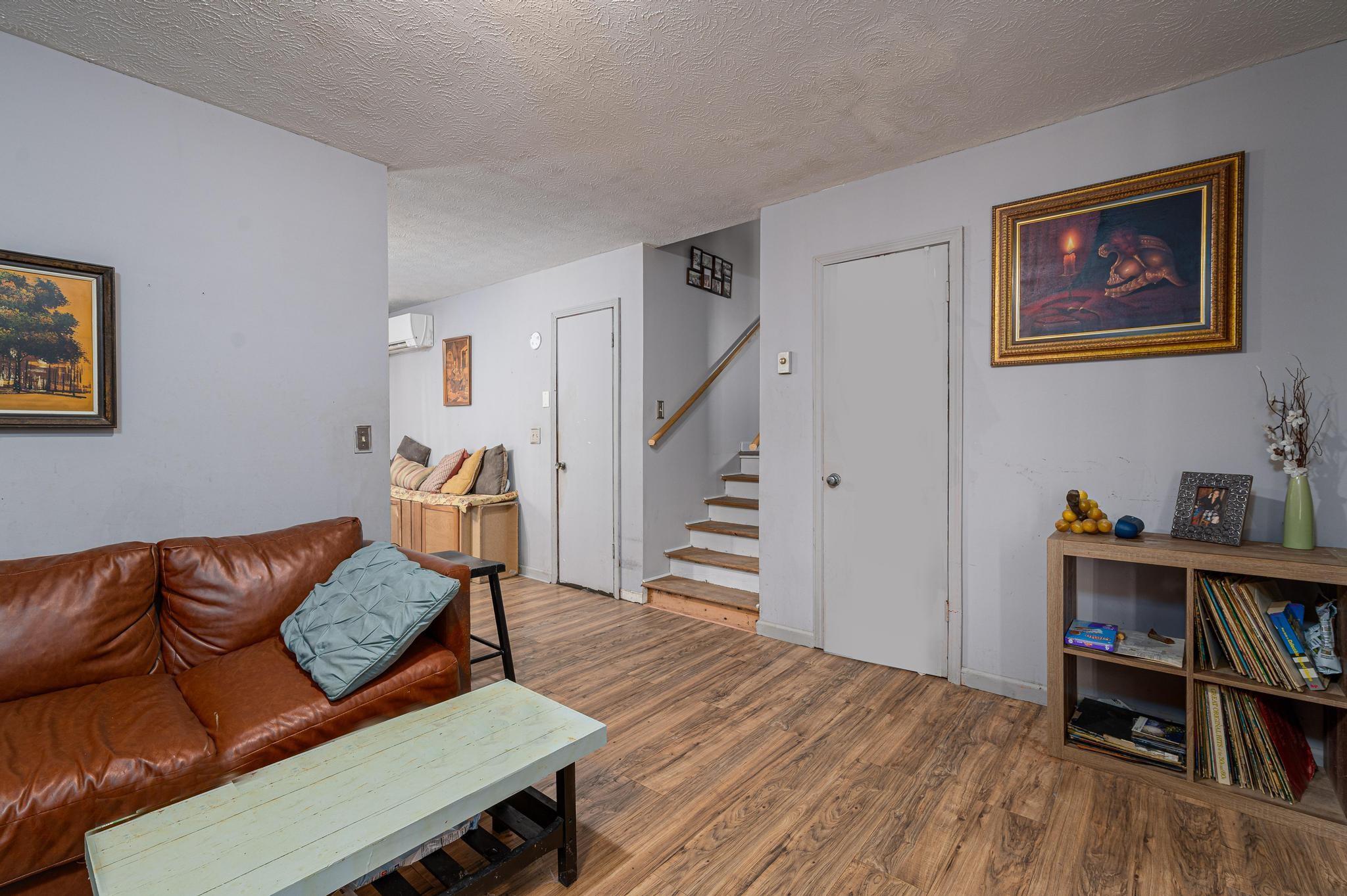 2 Laurel Brook Drive Flat Rock, NC 28731 - Photo 9 of 32 a living room with furniture and a book shelf with wooden floor