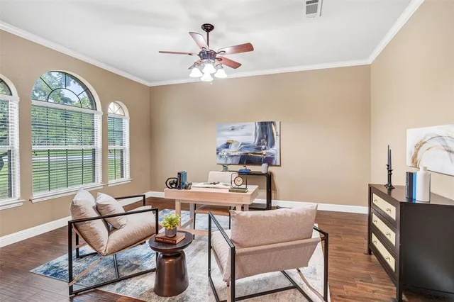 a living room with furniture a chandelier and a window