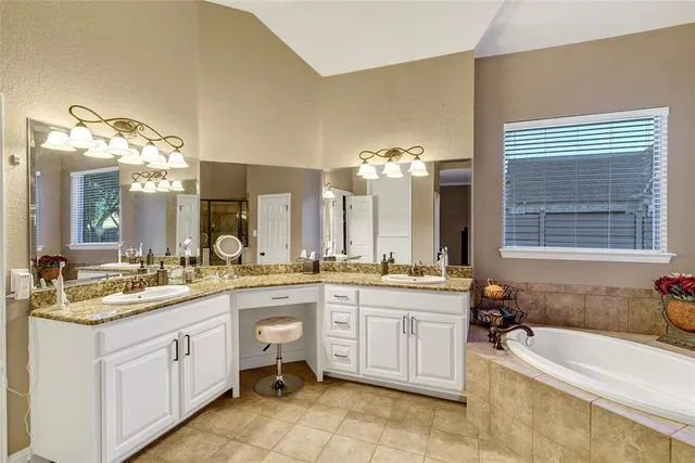 a spacious bathroom with a granite countertop sink and a mirror